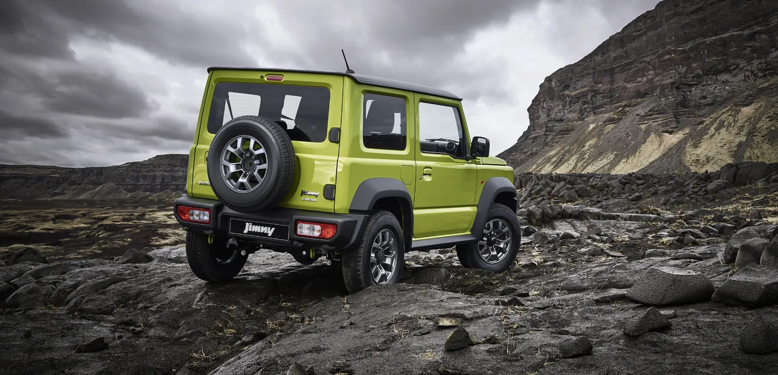 Suzuki Jimny parked in an open rocky landscape