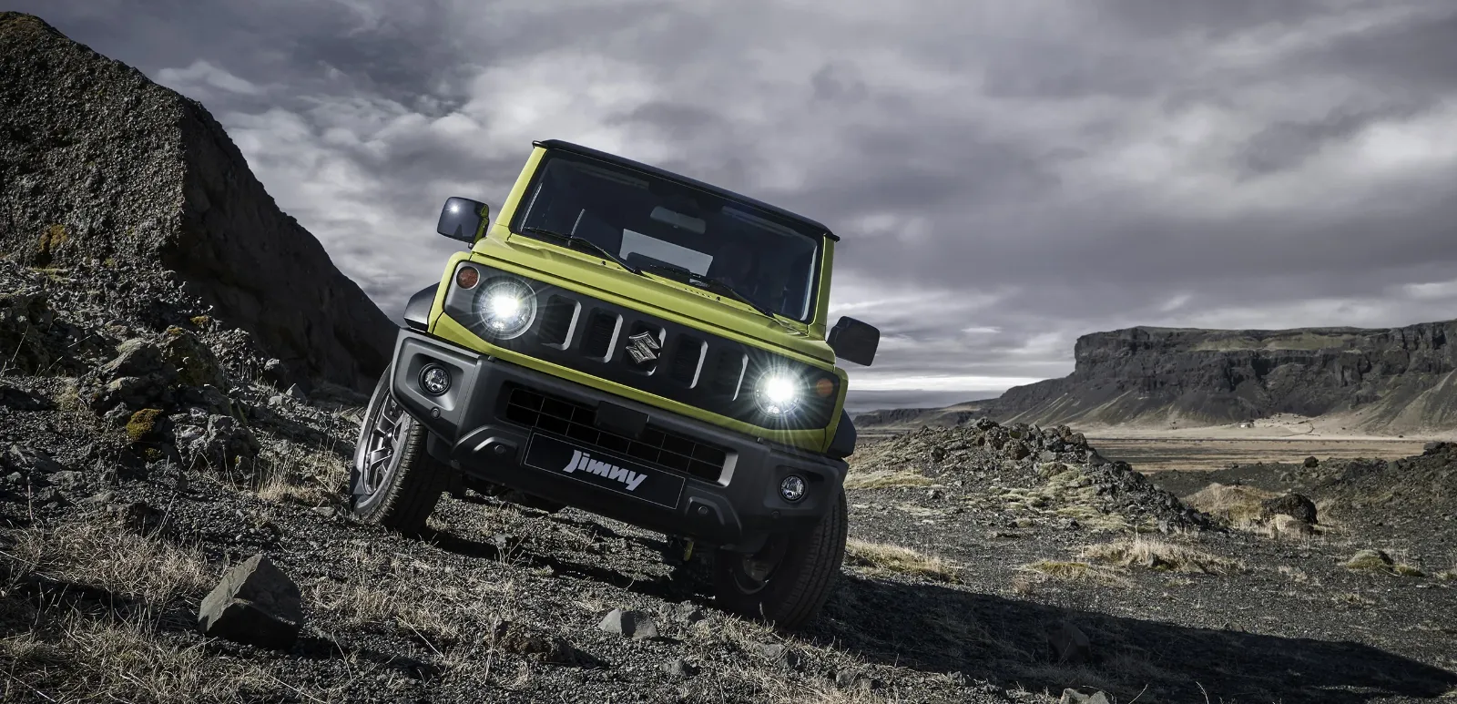 Suzuki Jimny off-roading through rocky mountains