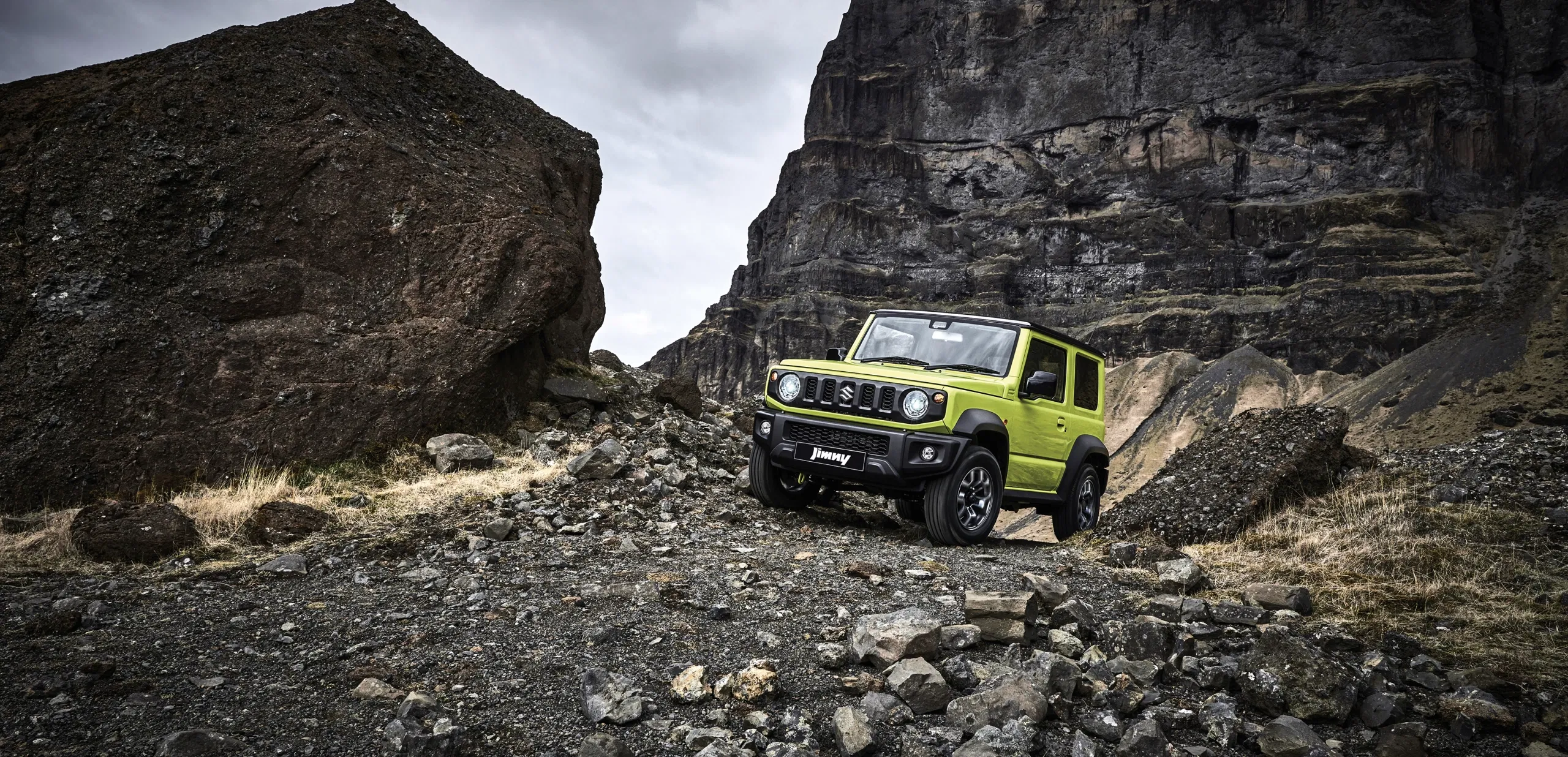 Suzuki Jimny parked in an open rocky landscape