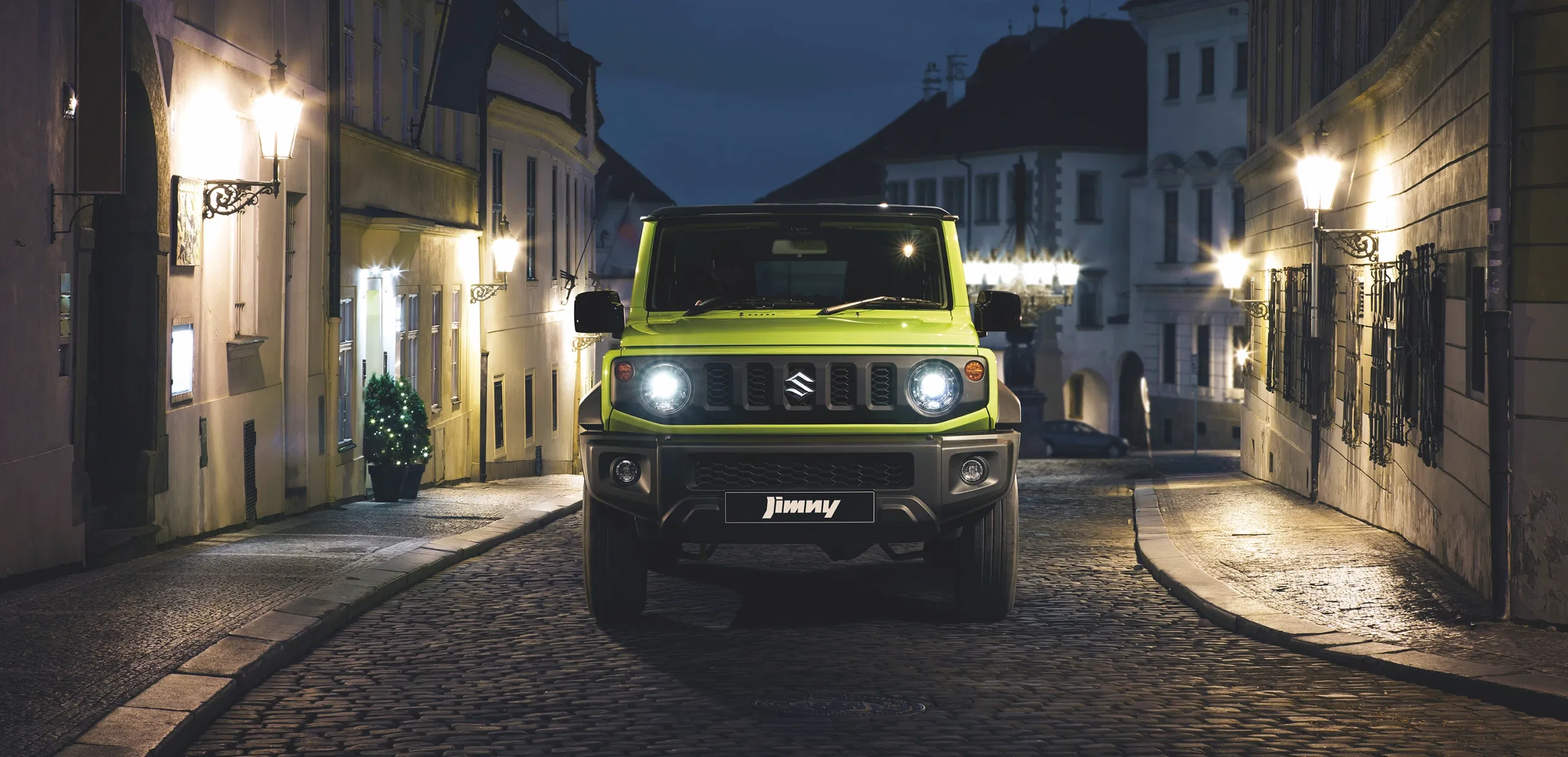 Green Suzuki Jimny exploring a dense forest trail