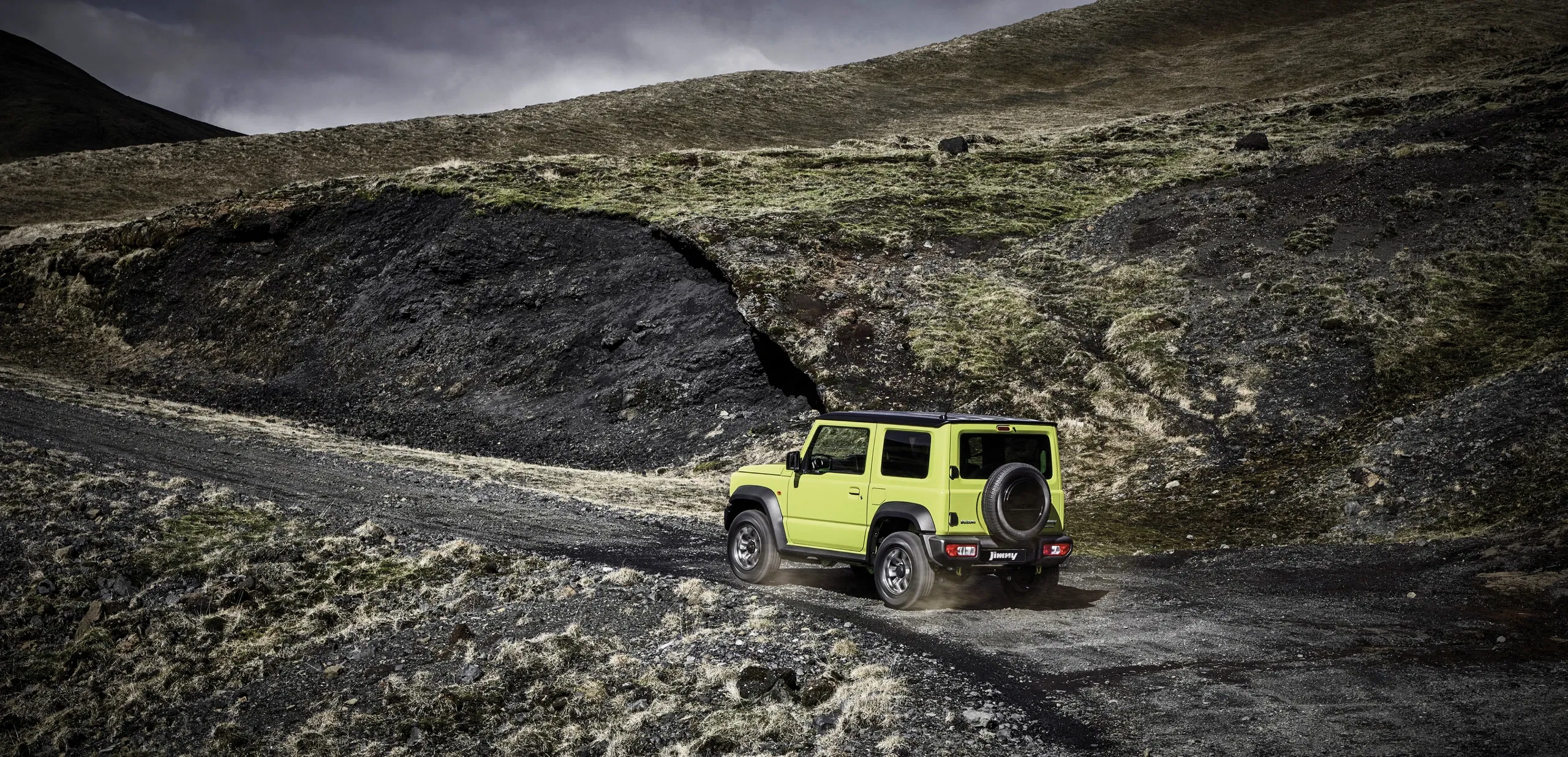 Suzuki Jimny driving over rugged rocky terrain