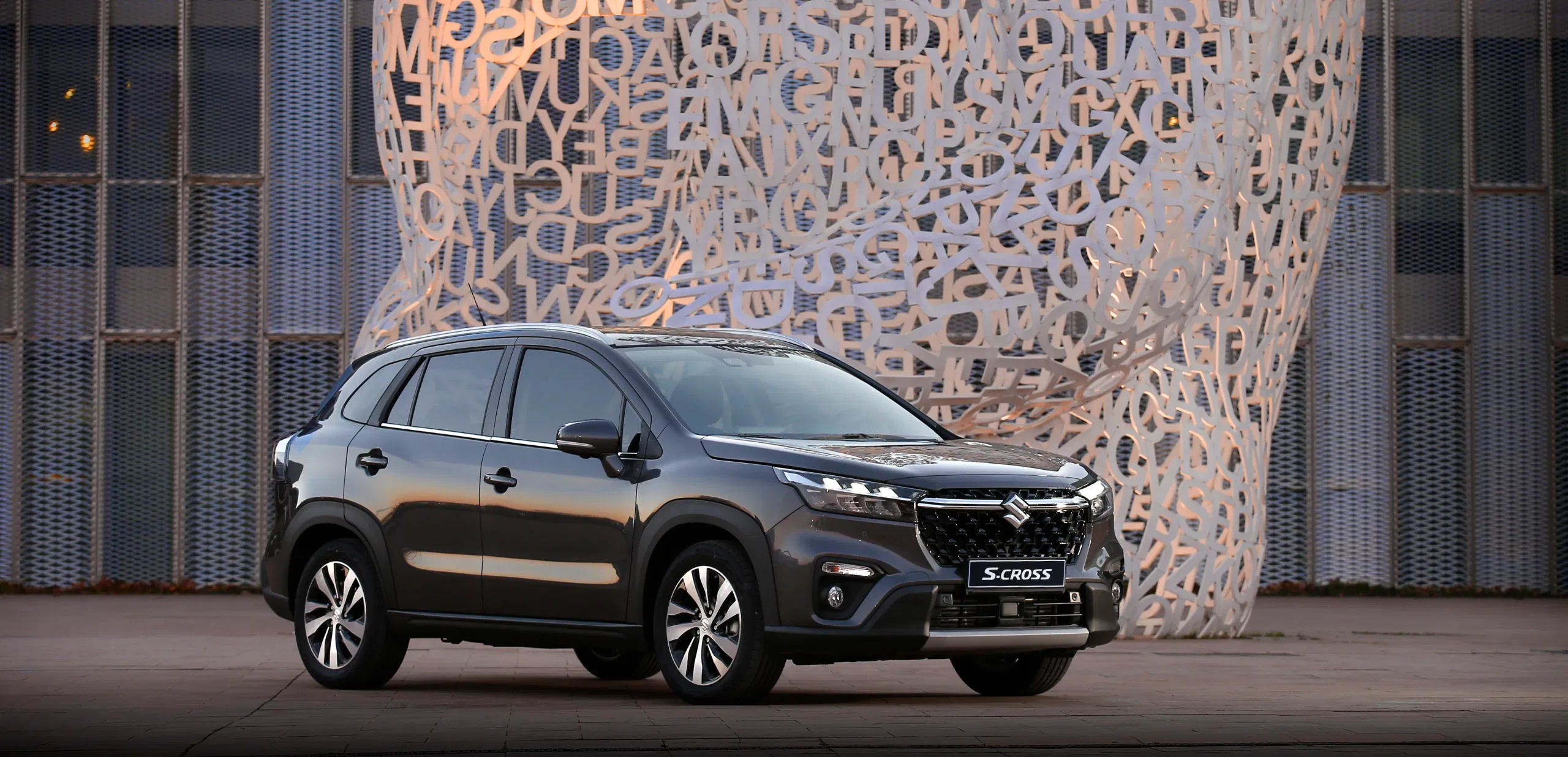 S-Cross SUV parked in front of a contemporary building